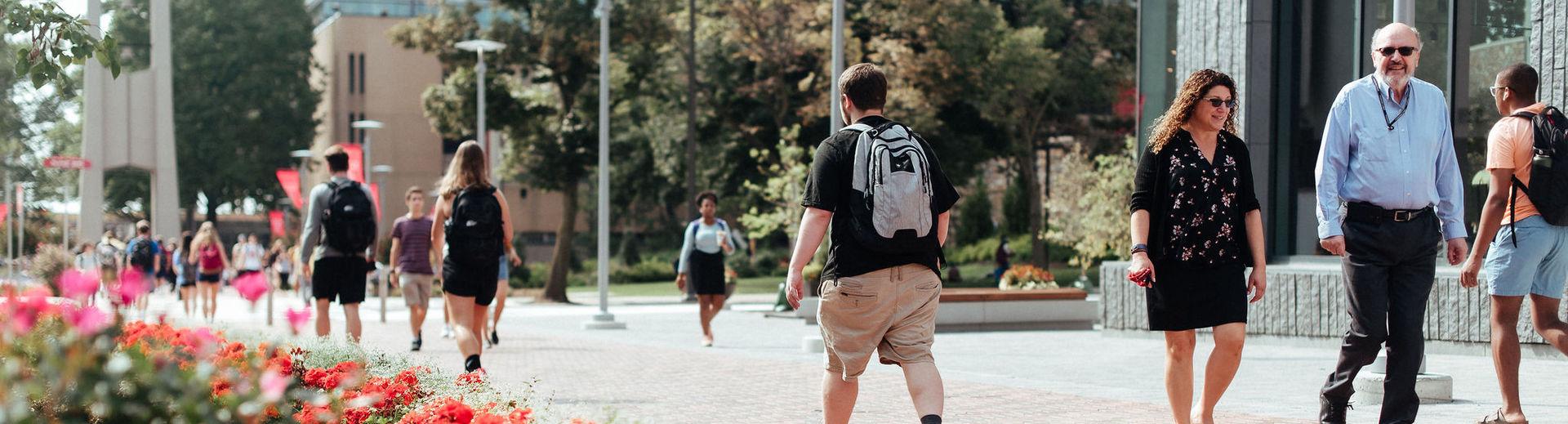 Temple students walk across Polett Walk between classes on Main Campus.