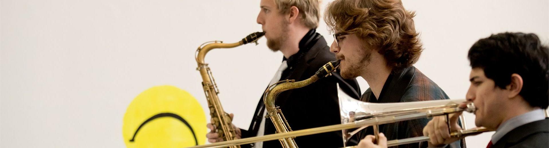 Three students playing saxaphones