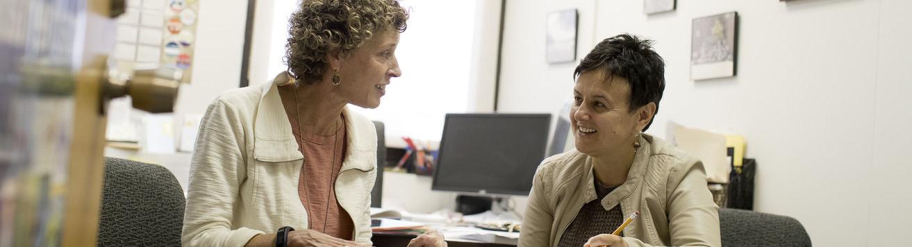 An image of two women having a conversation at a table