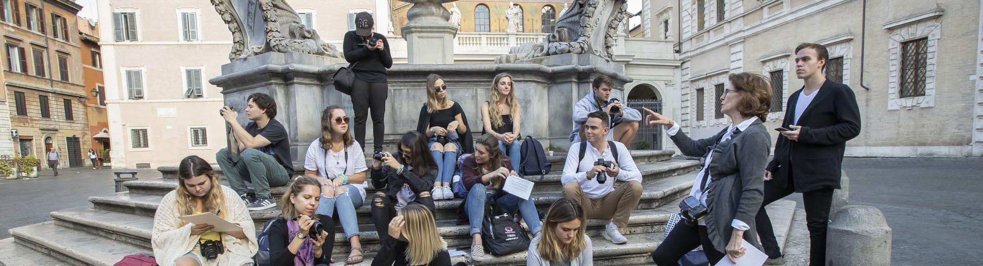 A group of Temple students gather at a fountain in Rome, Italy.