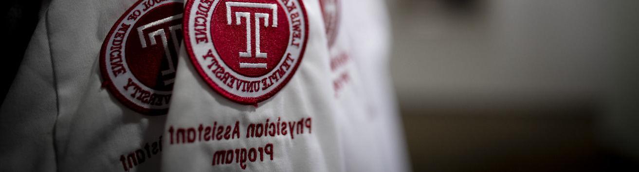 A close up of a white coat with the Katz School of Medicine logo that says Physician Assistant program