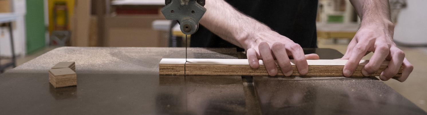 An image of a student using a tool to create a sculpture