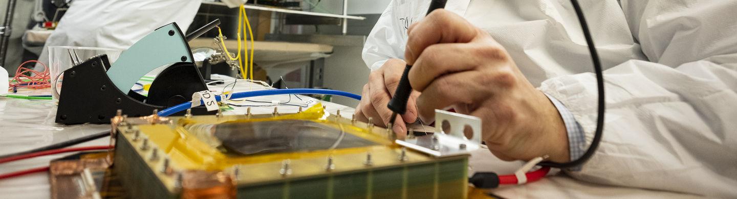 An image of an instructor conducting a physics experiment.