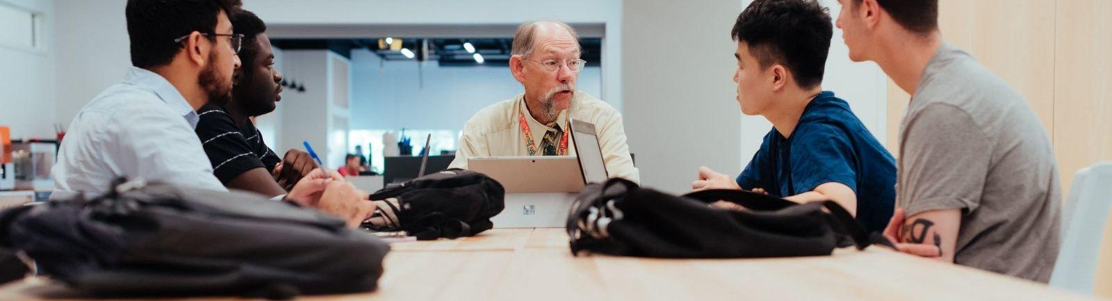 An Engineering Management professor addresses a cohort of students.