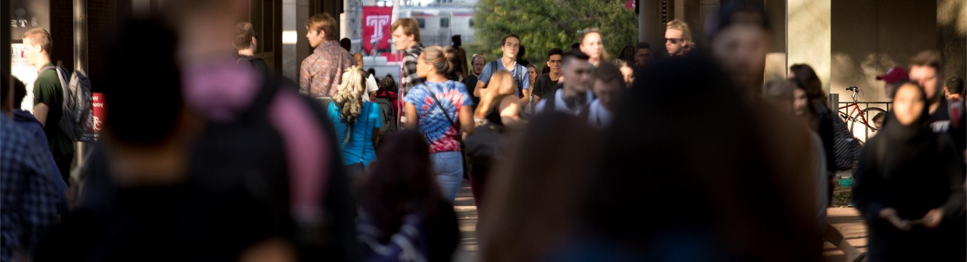 student walking on campus during a class change 