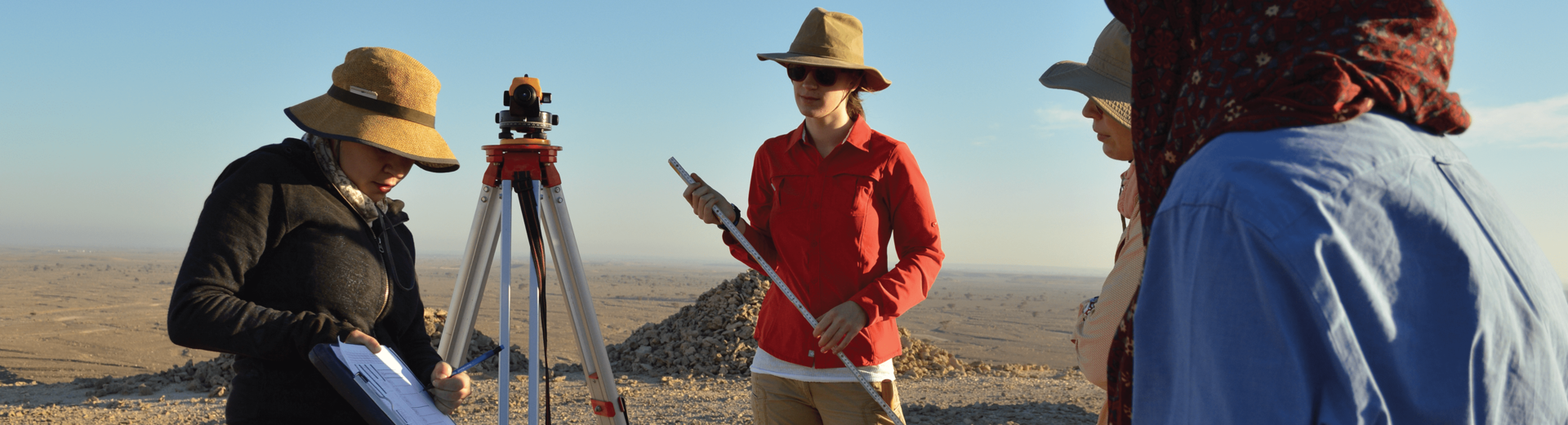 Four Temple Anthropology students participating in fieldwork outdoors.