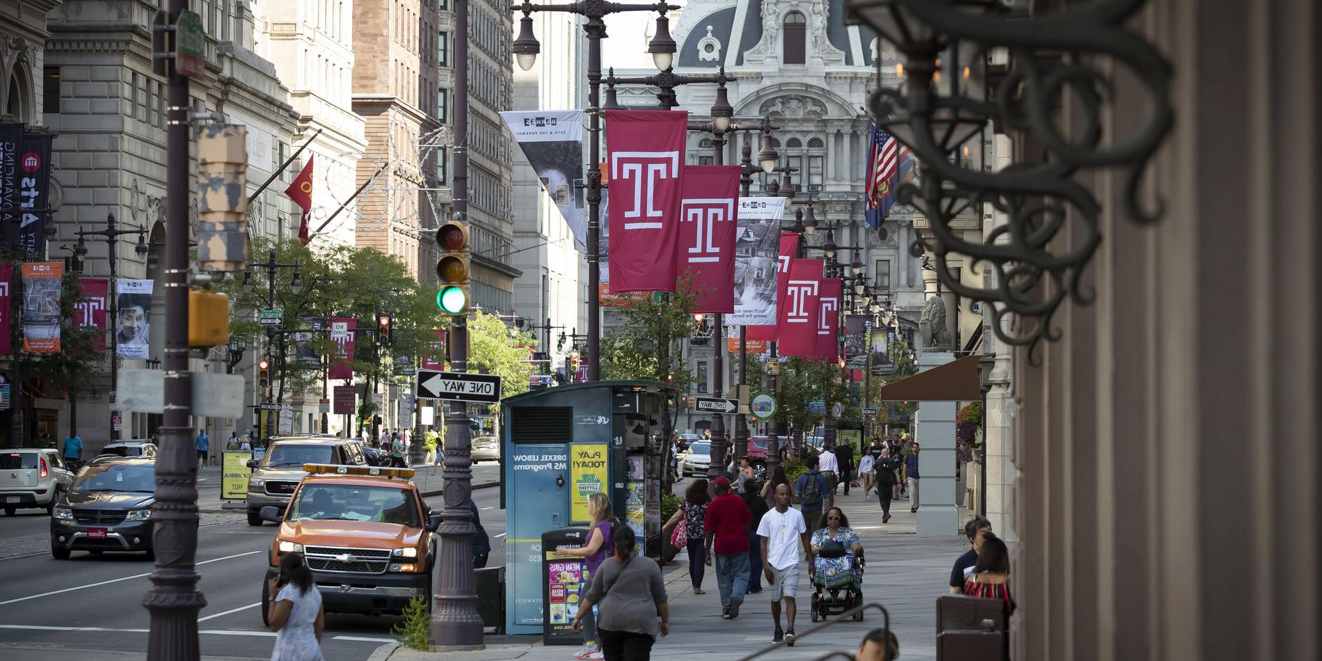 Cherry red Temple T flags line Market Street in front of City Hall.