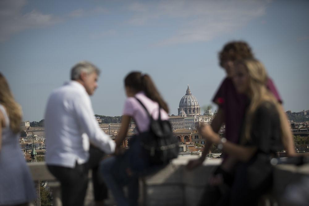 Tourists gather on a rooftop in Rome, Italy.