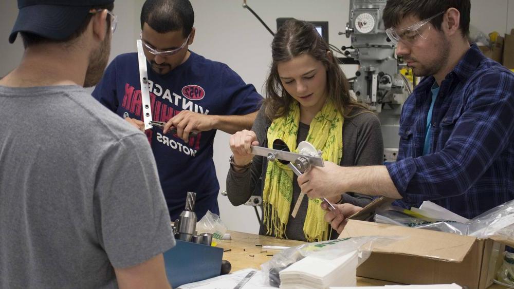 Mechanical engineering students collaborating in class