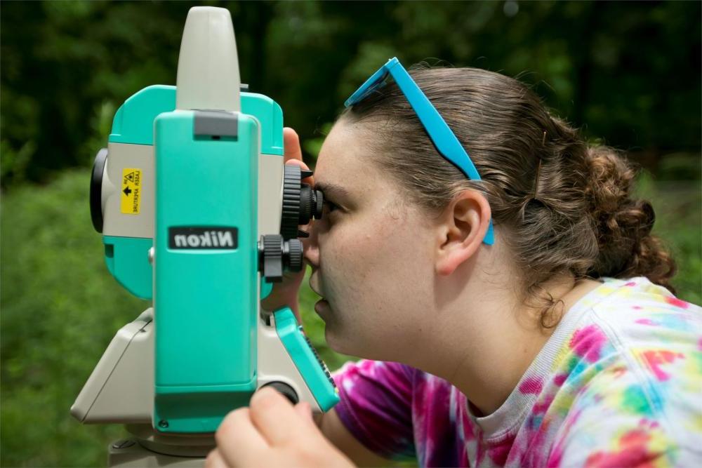 Environmental Science student examining foliage through a microscope